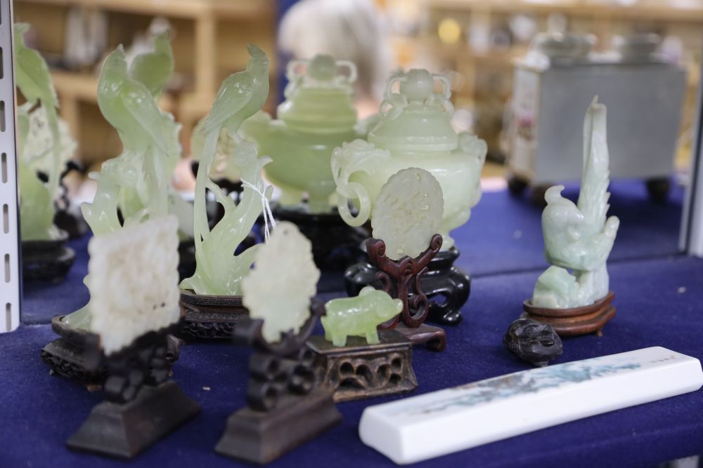 A group of Chinese jades and hardstone carvings on stands and a porcelain plaque, tallest 19cm incl. stand